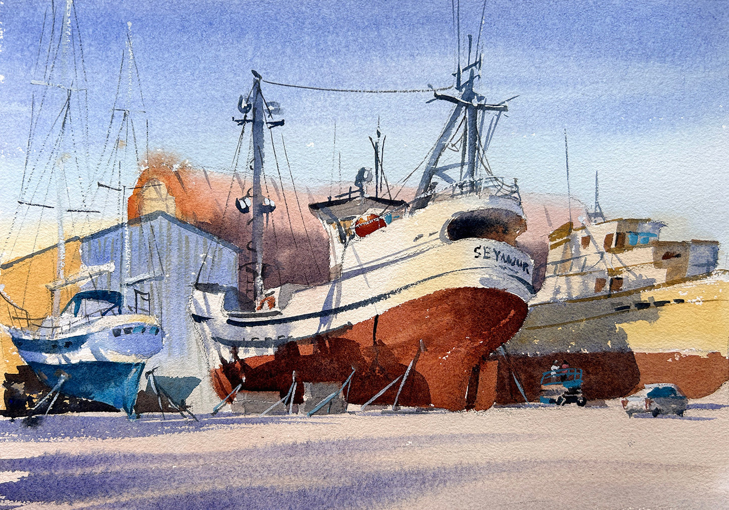 Shipyard with fishing boats docked and workers doing repairs at Port Townsend Shipwright and Boatyard